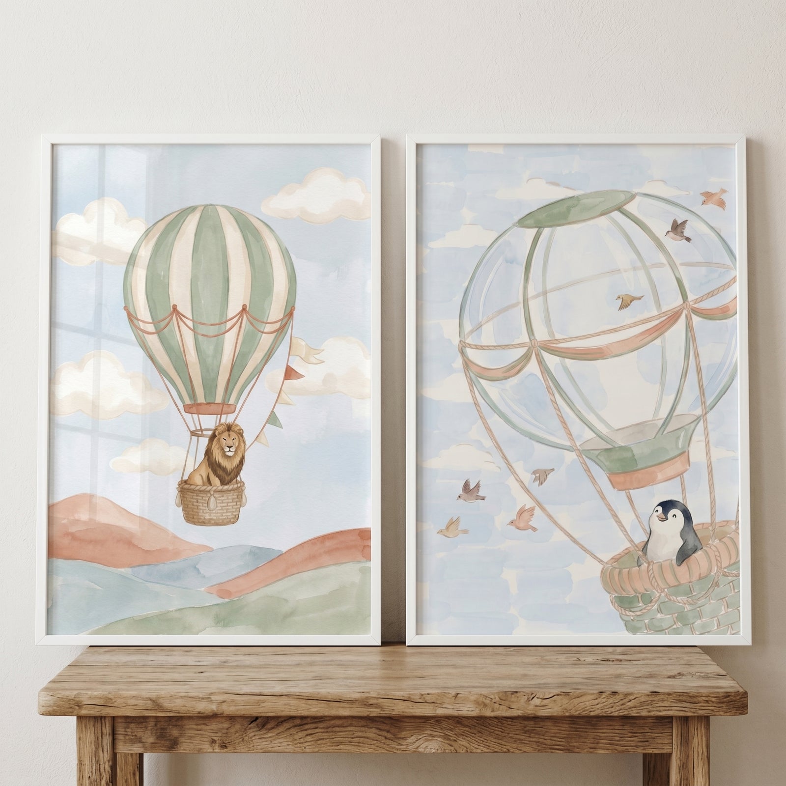 Sage air balloon animals wall art set of 2 featuring a lion and a penguin in hot air balloons among hills and clouds.