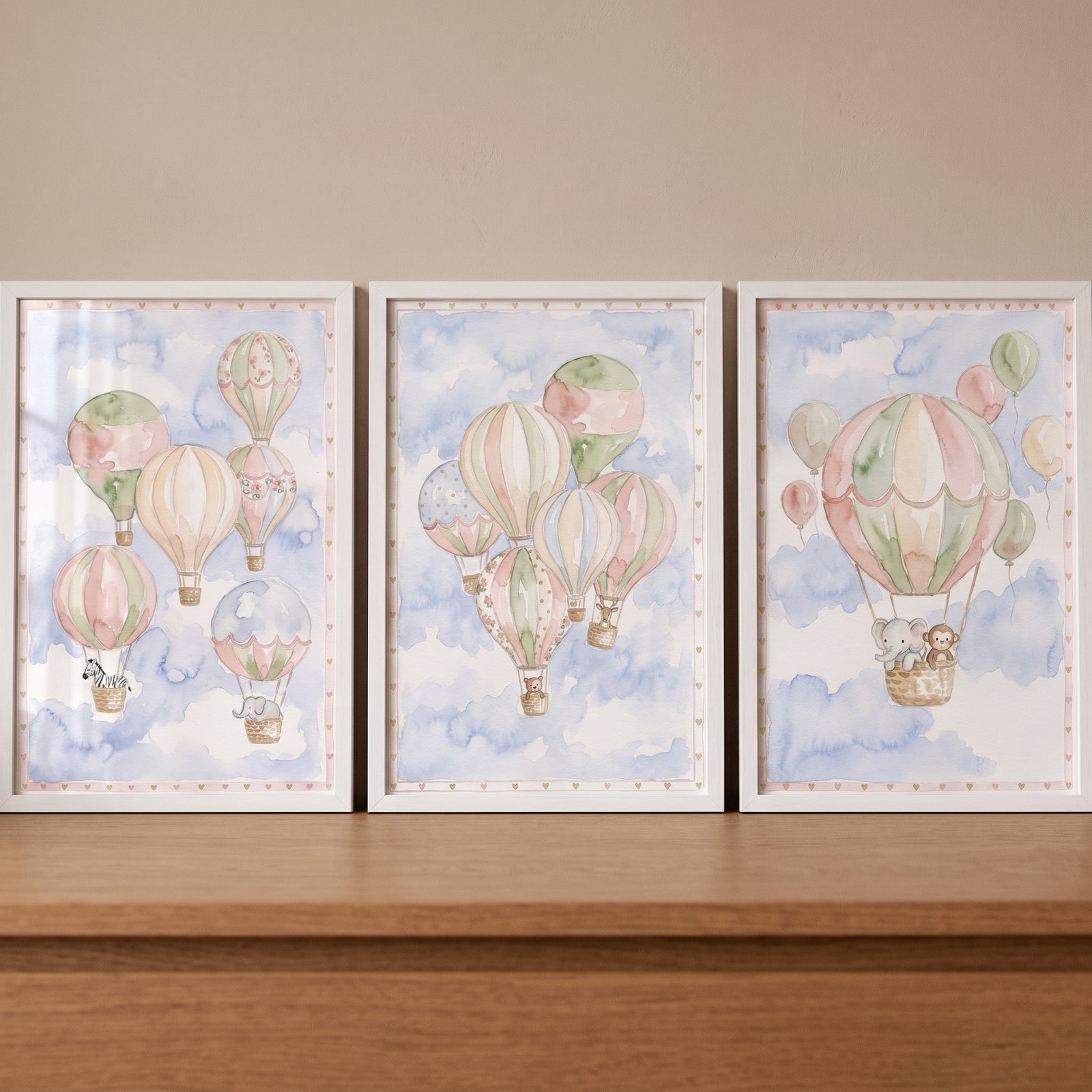 Sage blush animal balloon wall art set of 3 features cute animals in hot air balloons over soft watercolor clouds.