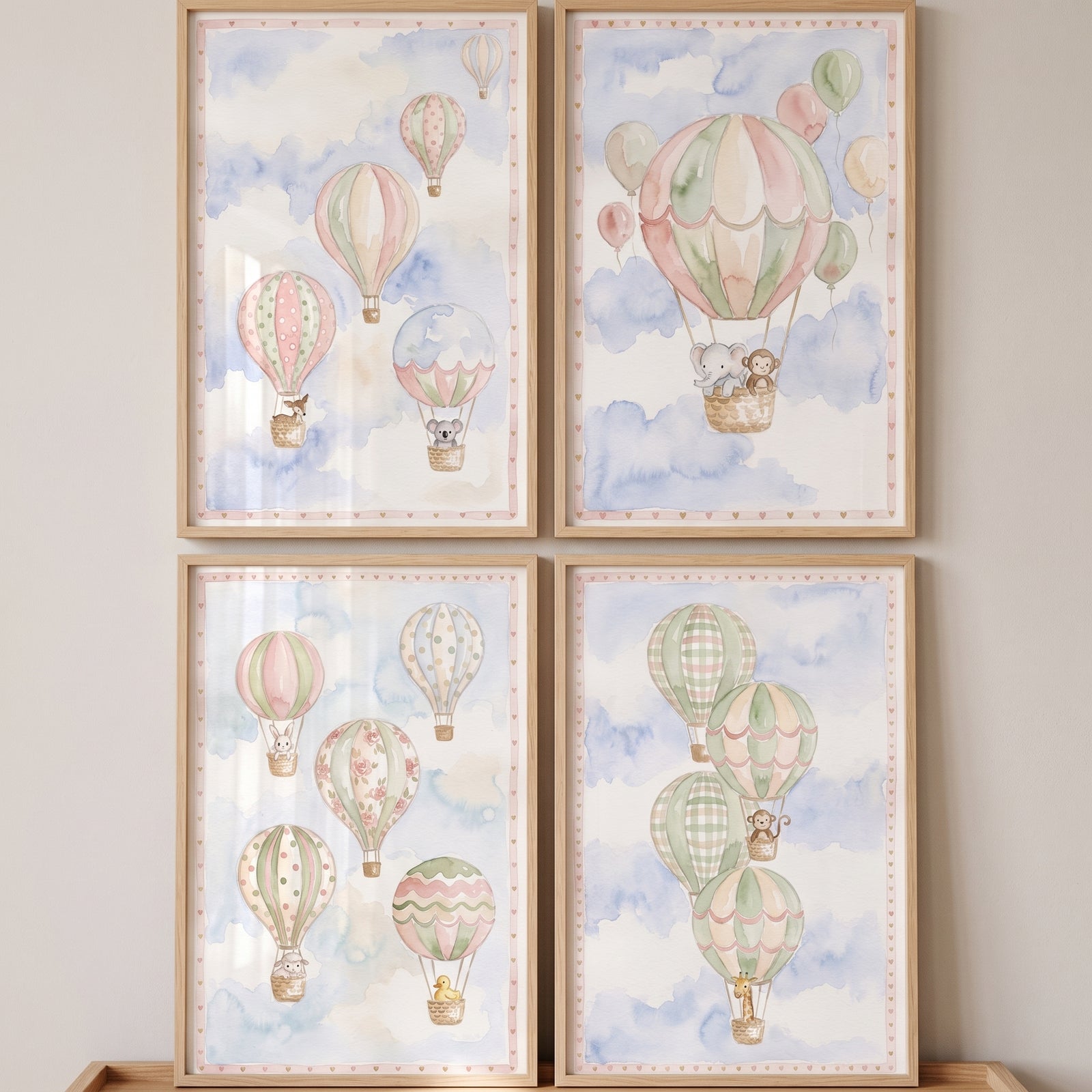 Sage green animal balloon wall art set of 4 features baby animals in watercolor hot air balloons and soft clouds.