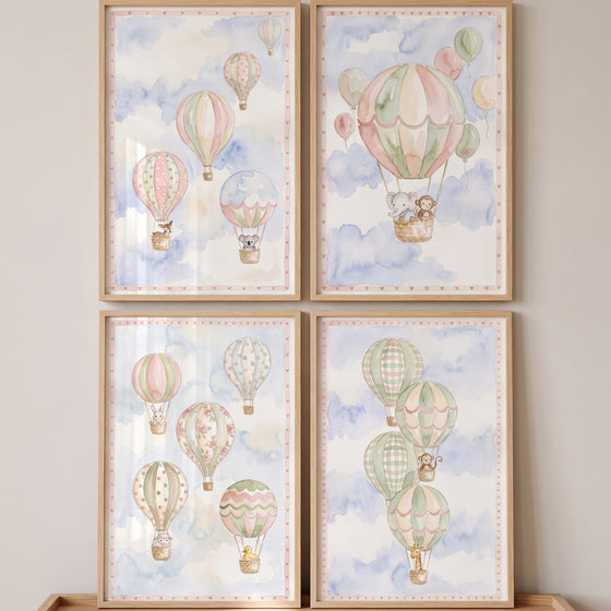 Sage green animal balloon wall art set of 4 features baby animals in watercolor hot air balloons and soft clouds.
