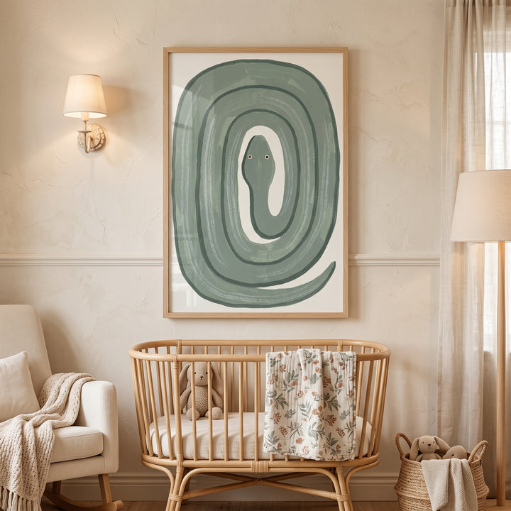 Sage green coiled snake wall art hangs in a wood frame above a rattan crib in a cozy, neutral-toned nursery.