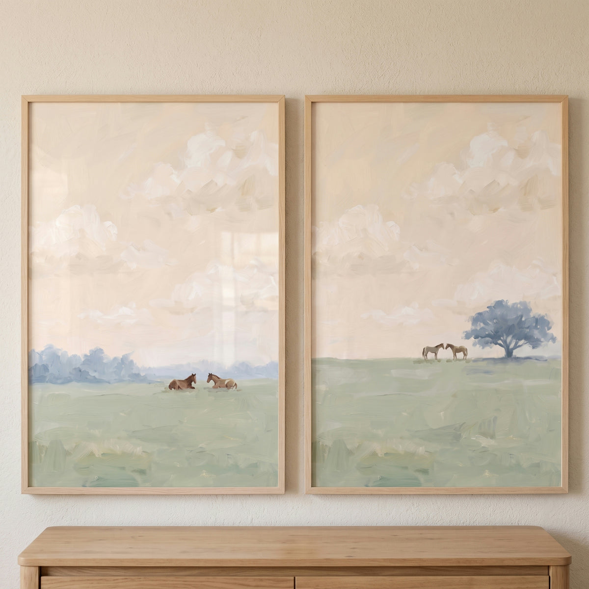 Sage green countryside horses wall art set of 2 depicts horses in soft landscapes with hazy clouds in wooden frames.