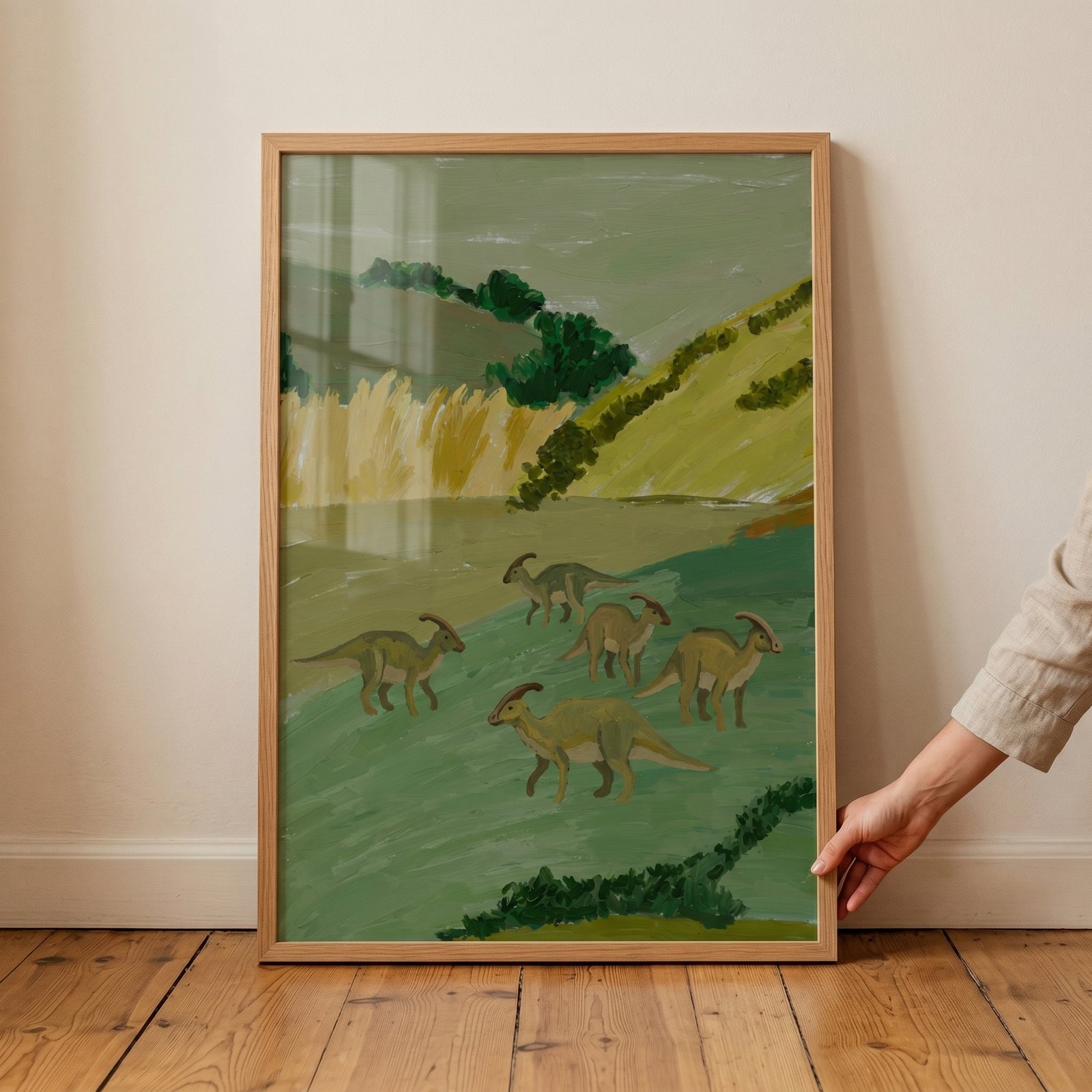 Framed sage green hill dinosaur artwork depicting five crested dinosaurs roaming a green landscape.