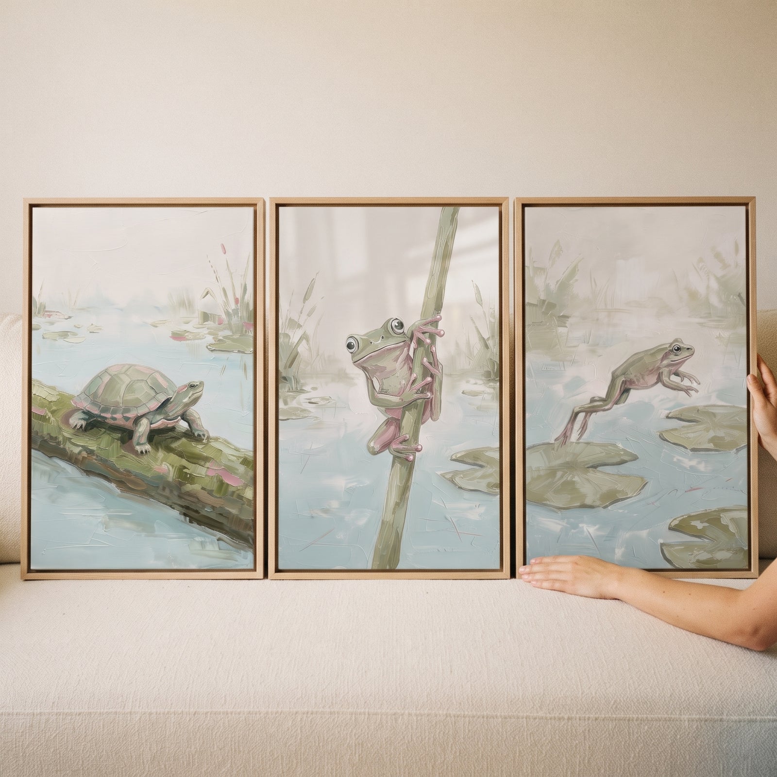 Sage green pond animals wall art set of 3 featuring a turtle on a log, a frog on a reed, and a leaping frog.