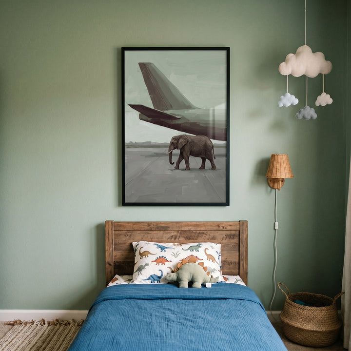 Sage green runway elephant wall art above a child's wooden bed with blue bedding, dinosaur pillow, and cloud mobile.