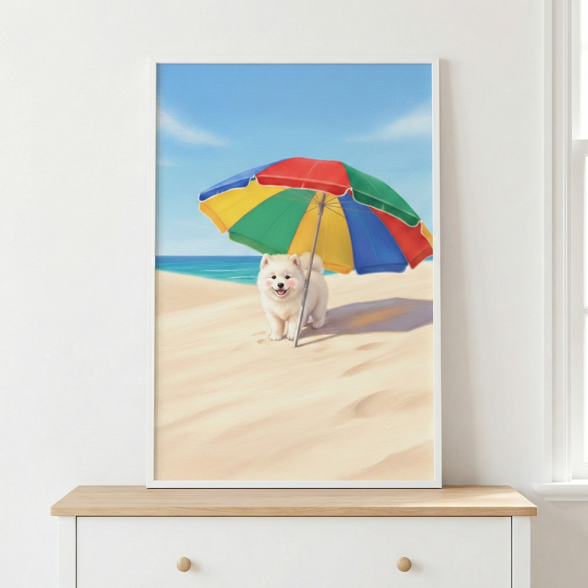 A framed illustration depicts a small, fluffy white dog with a joyful expression and rosy cheeks sitting on a sandy beach. The dog is sheltered by a large, multi-colored beach umbrella featuring panels of red, yellow, green, and blue. The background shows a calm turquoise sea meeting a pale blue sky with light clouds. This artwork is mounted on a plain white wall above a light wooden dresser, creating a bright and airy coastal atmosphere in a room.