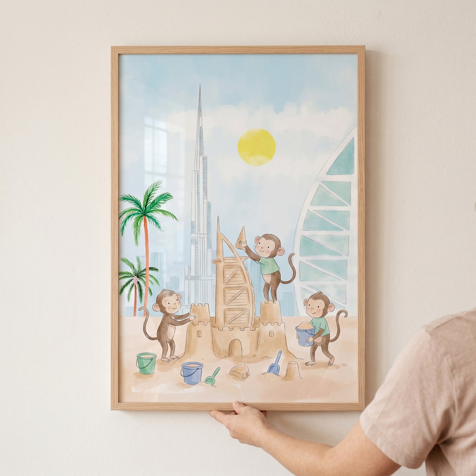 Watercolor sandcastle beach monkey wall art of cartoon monkeys building a sandcastle near palm trees and tall city towers.