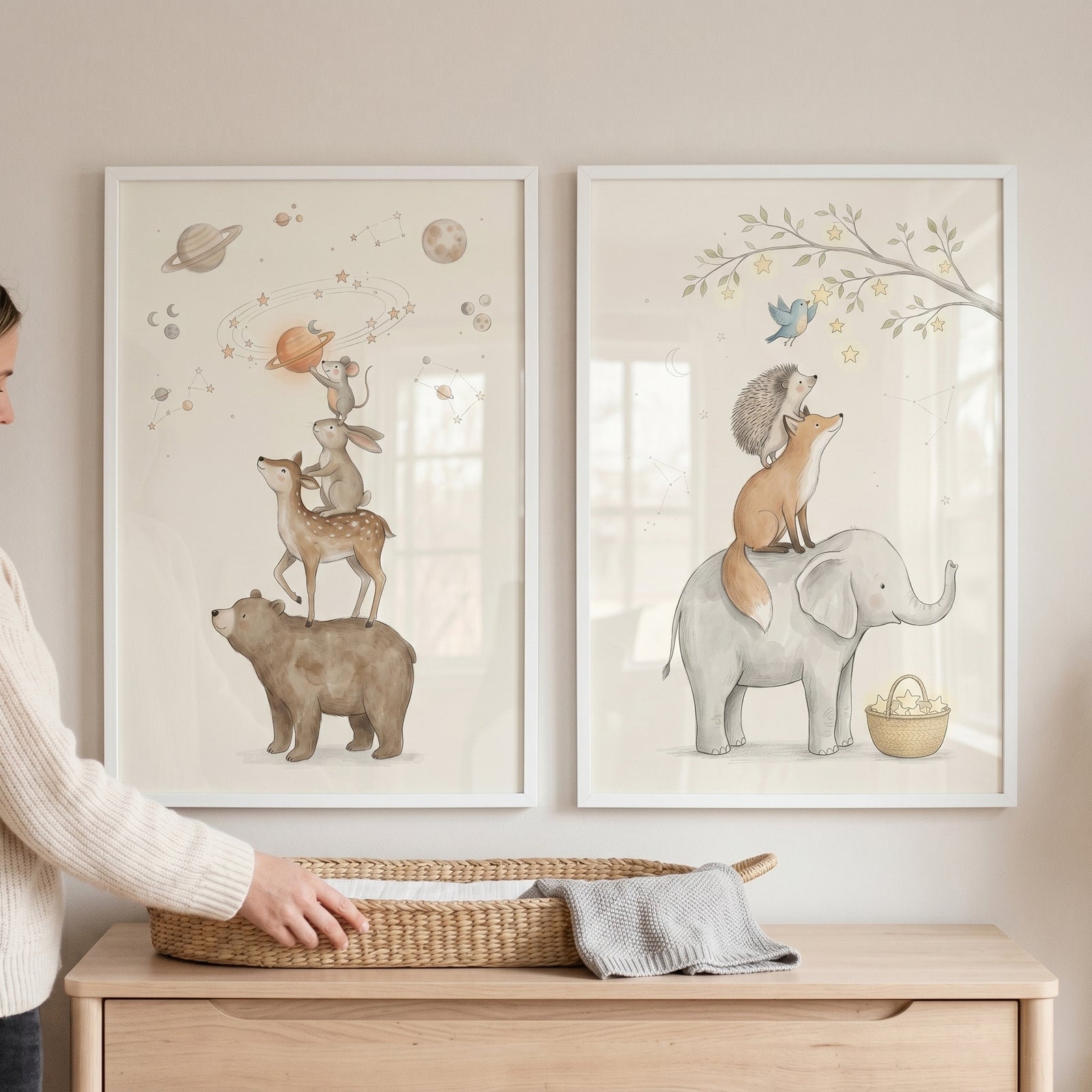 scandi neutral stacked animals wall art set of 2 hanging above a wooden dresser with a wicker changing basket.