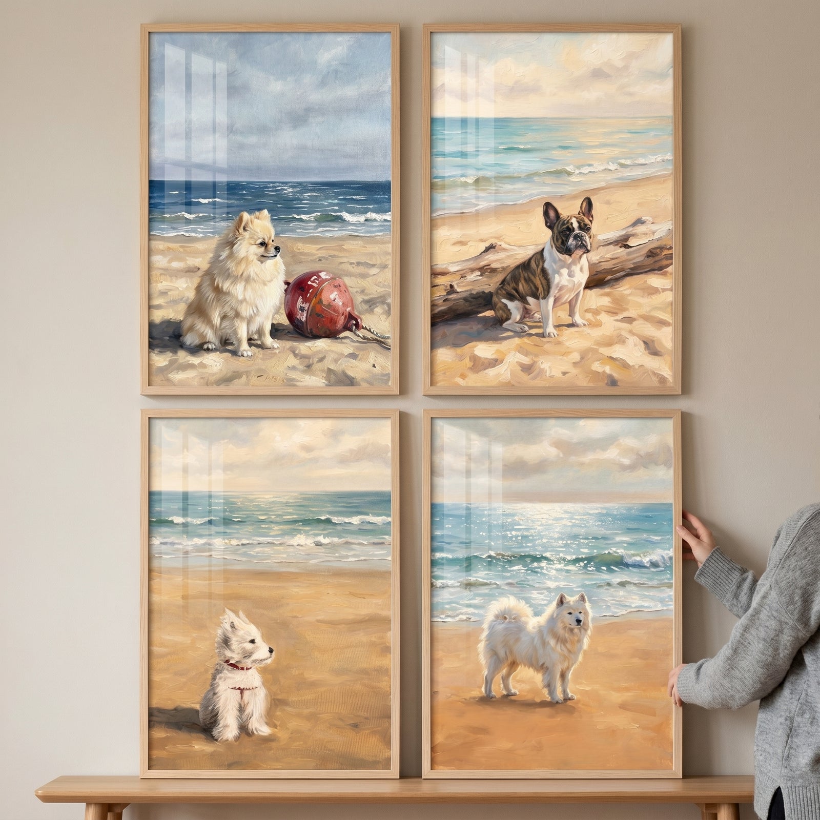 Scenic oceanfront beach dogs wall art set of 4 shows various dogs on the sand in light wood frames on a neutral wall.