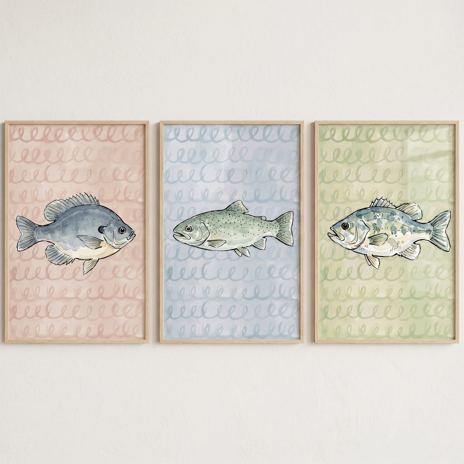 Scribble background watercolor fish wall art set of 3 with a bluegill, trout, and bass in light wood frames.