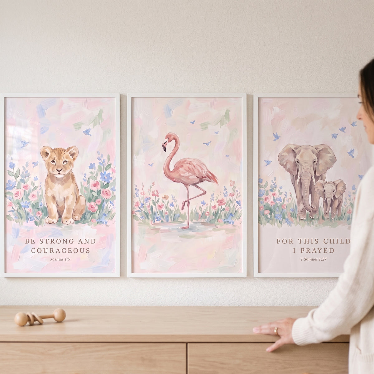 Scripture meadow savanna animals artwork set of 3 featuring a lion cub, flamingo, and elephants above a nursery dresser.