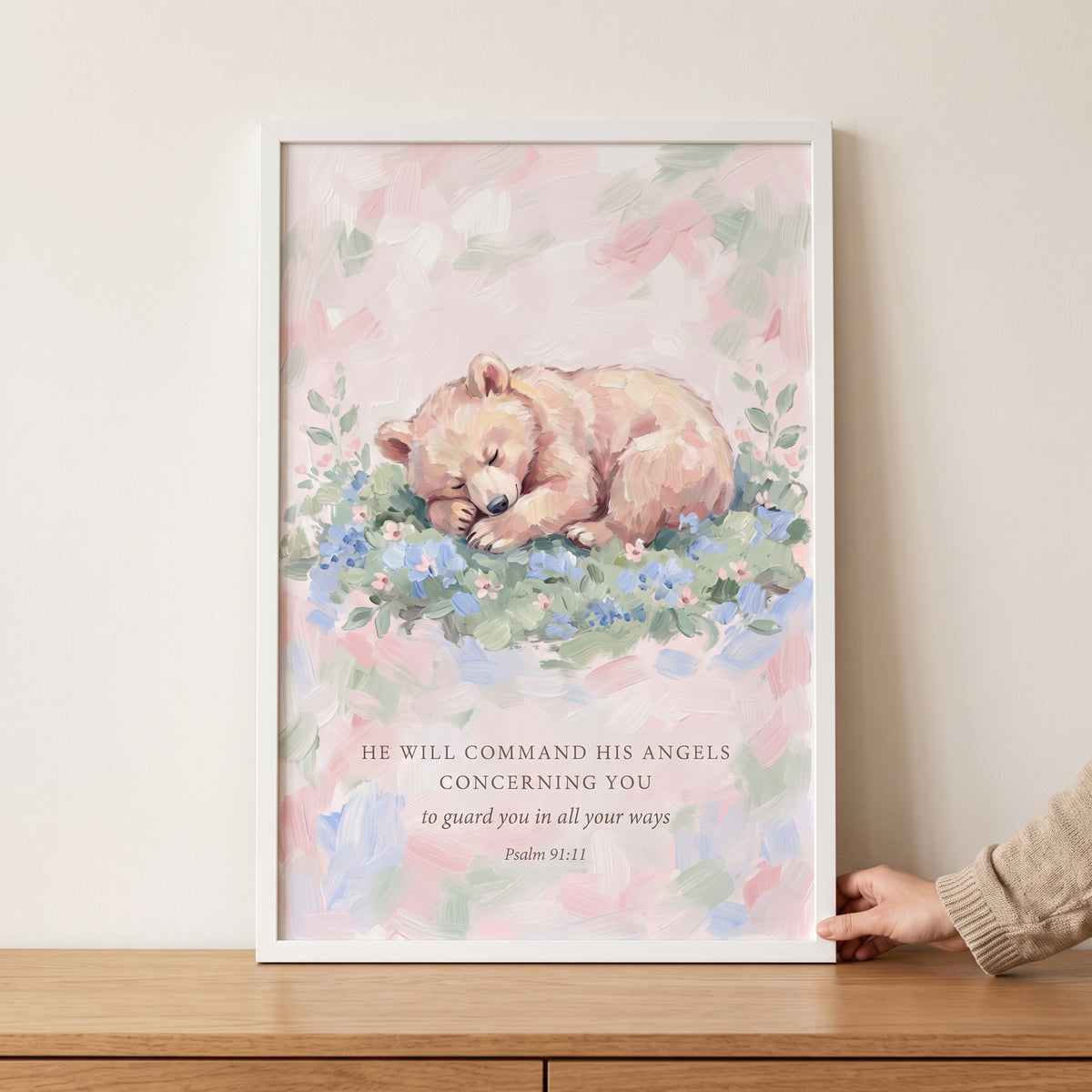 Scripture quote sleeping bear bible wall art with a cub on blue flowers and Psalm 91:11 text in a white frame.