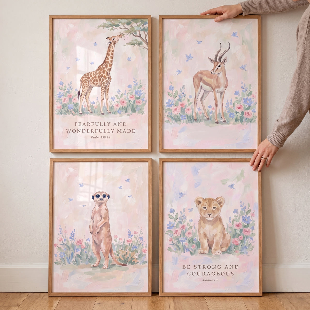 Scripture verse savanna animals artwork set of 4 featuring a giraffe, gazelle, meerkat, and lion cub in soft floral scenes.