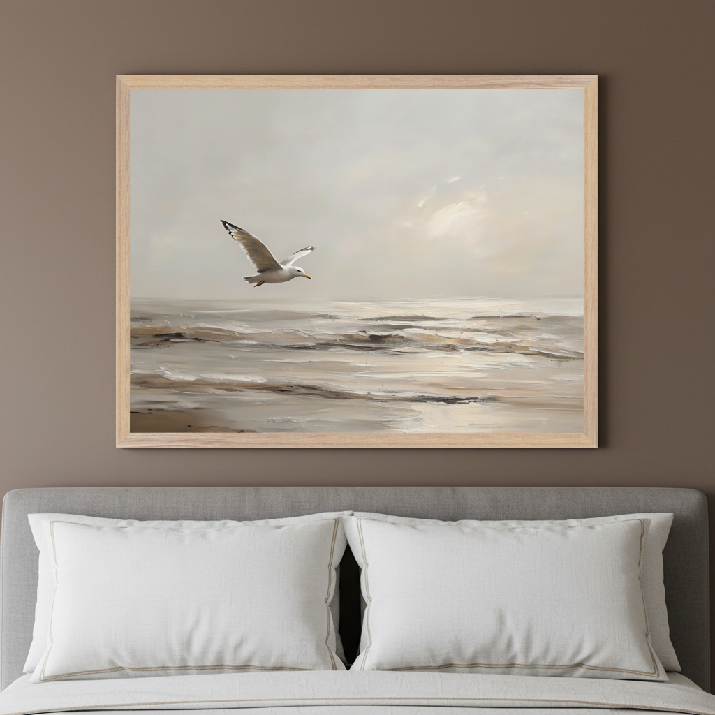 Modern bedroom with a gray upholstered bed. A large framed painting of a white seagull flying over a textured ocean with a cloudy sky hangs centered above the bed.