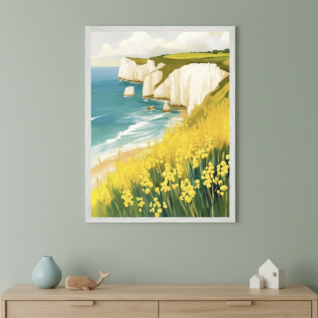 Modern room with a light wood dresser. A framed painting of white chalk cliffs by the blue sea, a sandy beach, and vibrant yellow flowers on a green hillside hangs centered above the dresser in a painterly style. A blue vase, wooden whale, and white houses are on the dresser.
