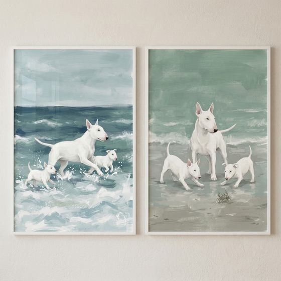 Two framed illustrations are displayed side-by-side on a neutral, textured wall. The artworks feature a family of white dogs with distinct, smooth, egg-shaped heads and small, pointed ears. The artistic style is expressive and soft, with visible, textured brushwork and a muted color palette.

