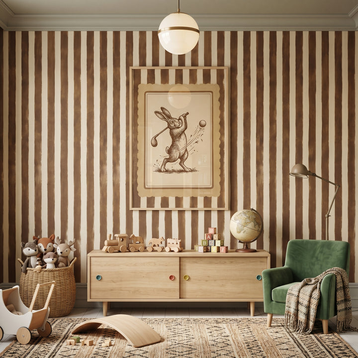 Striped room featuring sepia sketch golfing rabbit artwork, a wooden sideboard, green velvet armchair, and vintage toys.