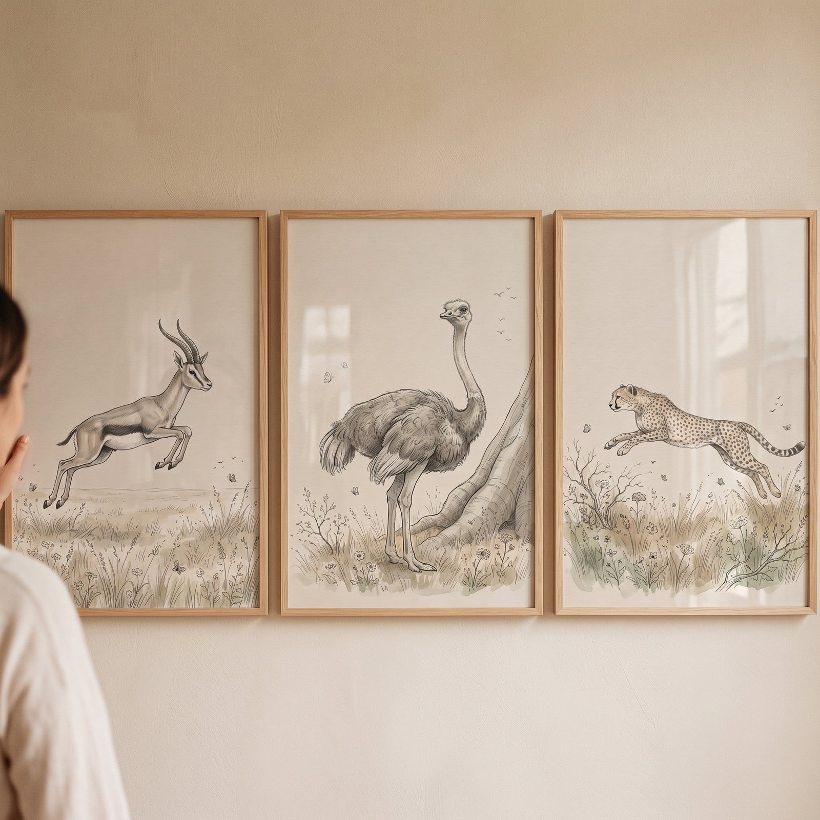 Sepia watercolor savanna animal wall art set of 3 featuring a leaping gazelle, an ostrich, and a running cheetah.
