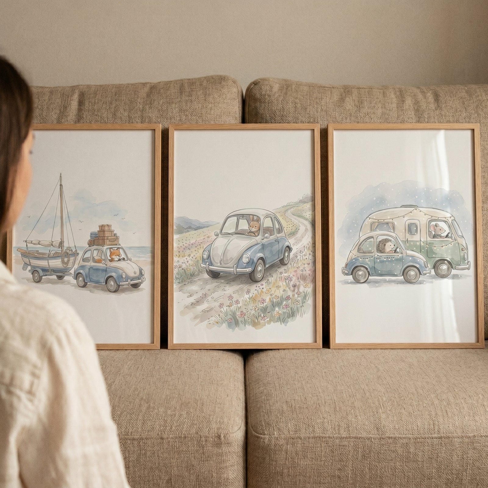 Serene blue car animals wall art set of 3 on a couch featuring whimsical watercolor illustrations of creatures in vehicles.