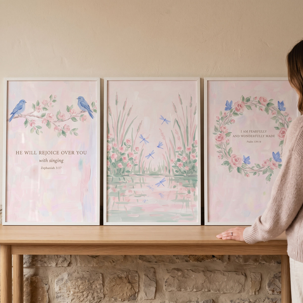 Serene blush nature scene wall art set of 3 features birds, a pond with dragonflies, and a floral wreath with scripture.