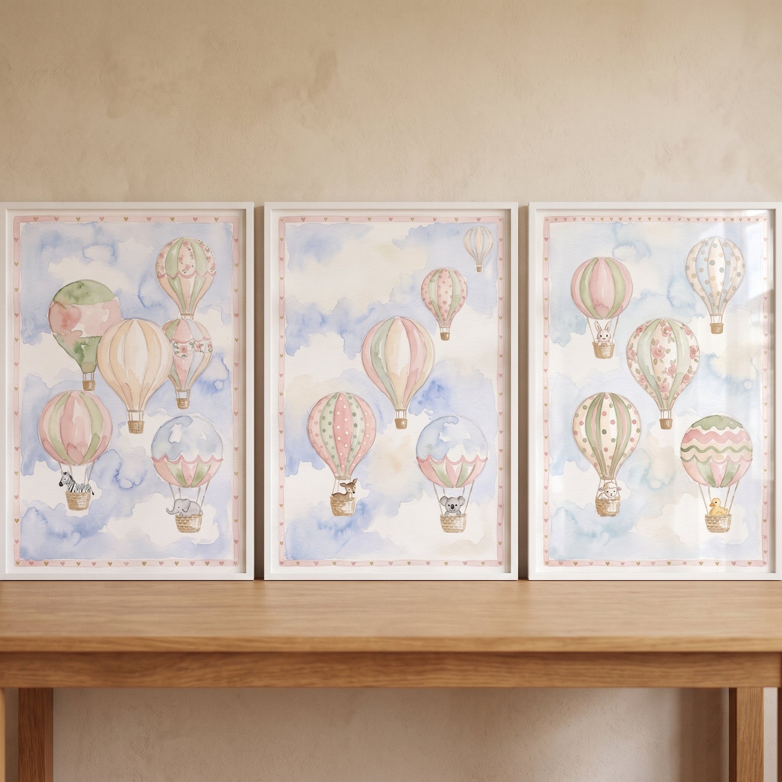 Serene floating animal balloon artwork set of 3 shows pastel watercolor animals in hot air balloons in white frames.