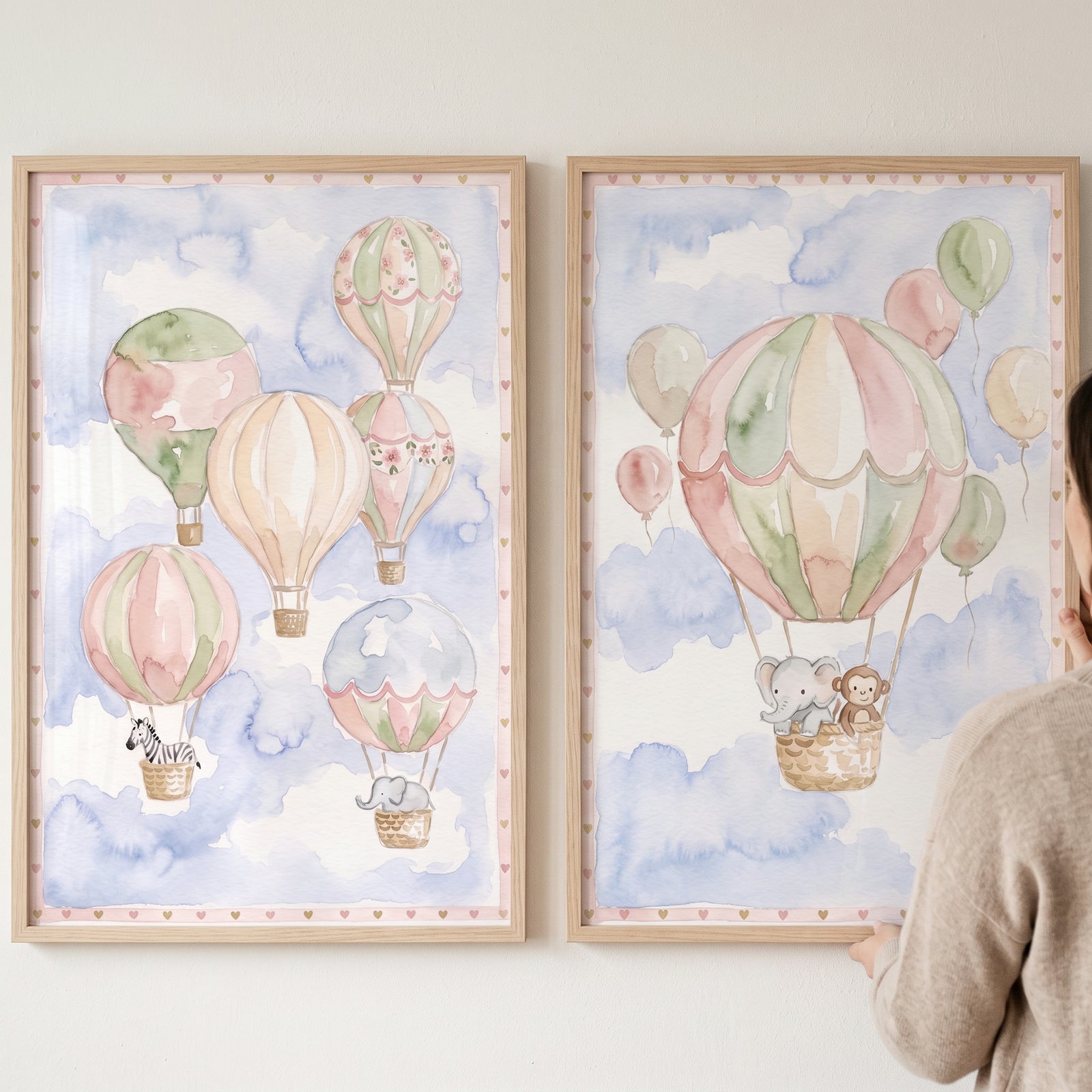 Serene hot air balloon wall art set of 2 with watercolor animal illustrations of an elephant, zebra, and monkey.