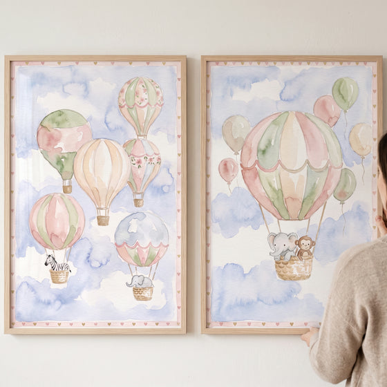 Serene hot air balloon wall art set of 2 with watercolor animal illustrations of an elephant, zebra, and monkey.