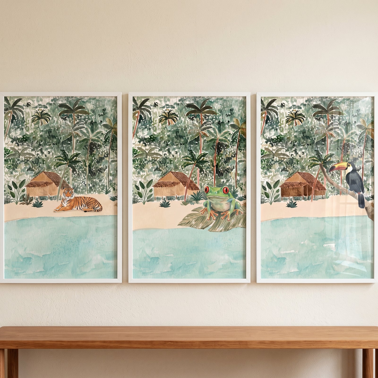 Serene island watercolor animals wall art set of 3 featuring a tiger, frog, and toucan near tropical beach huts.