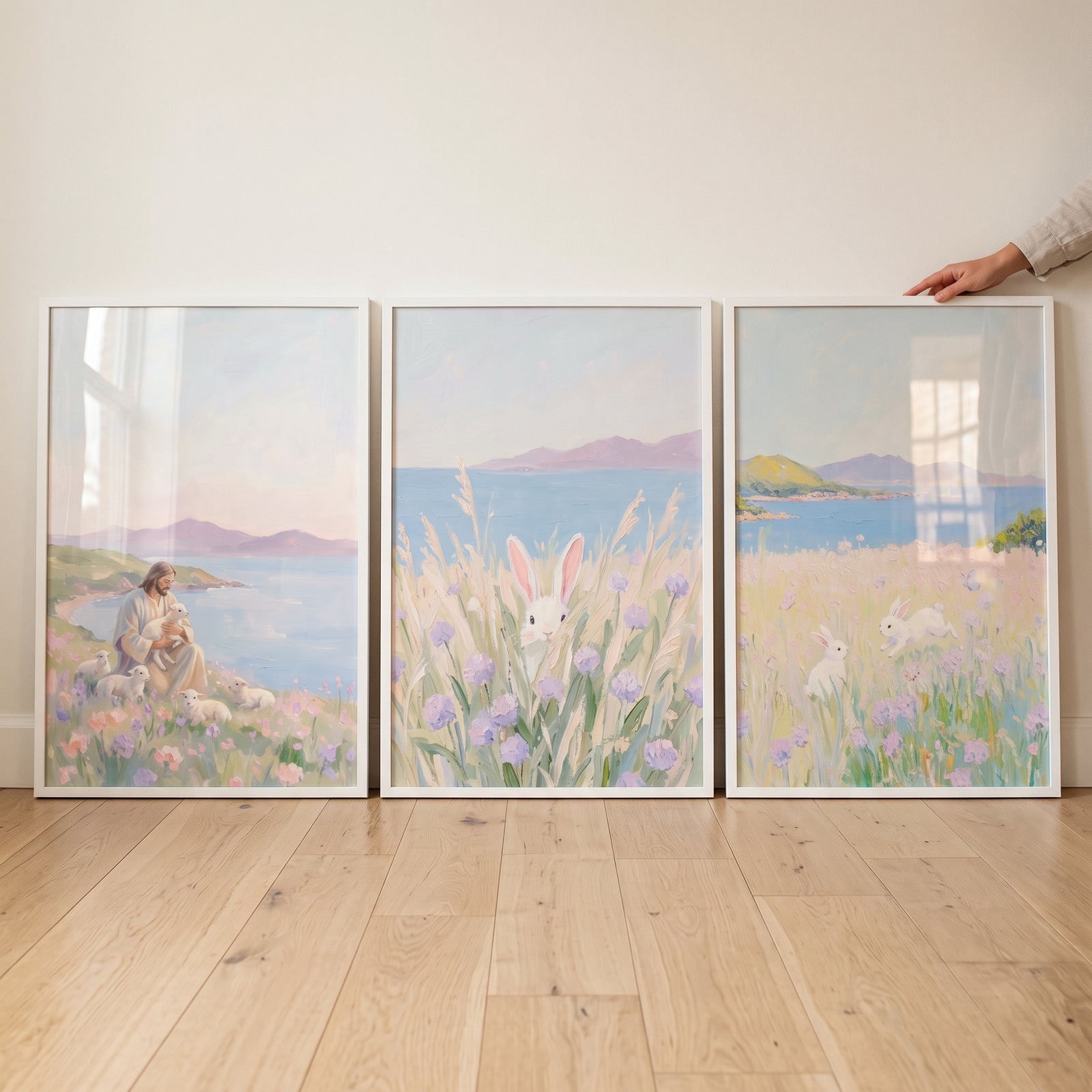 Jesus with lambs and rabbits in a serene lavender meadow coastal wall art set of 3 framed against a white wall.