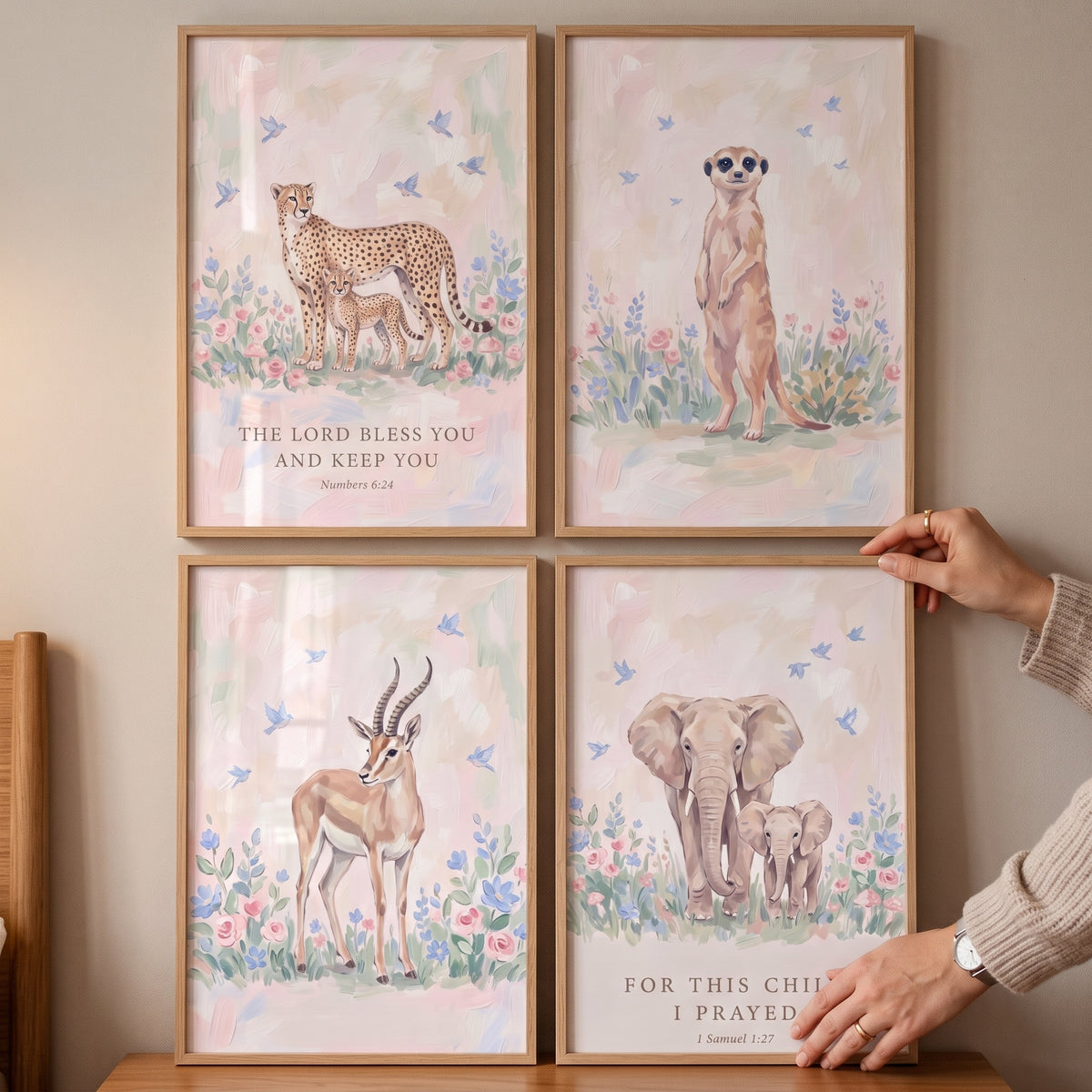 Serene meadow safari animals wall art set of 4 shows soft illustrations of a cheetah, meerkat, gazelle, and elephant.