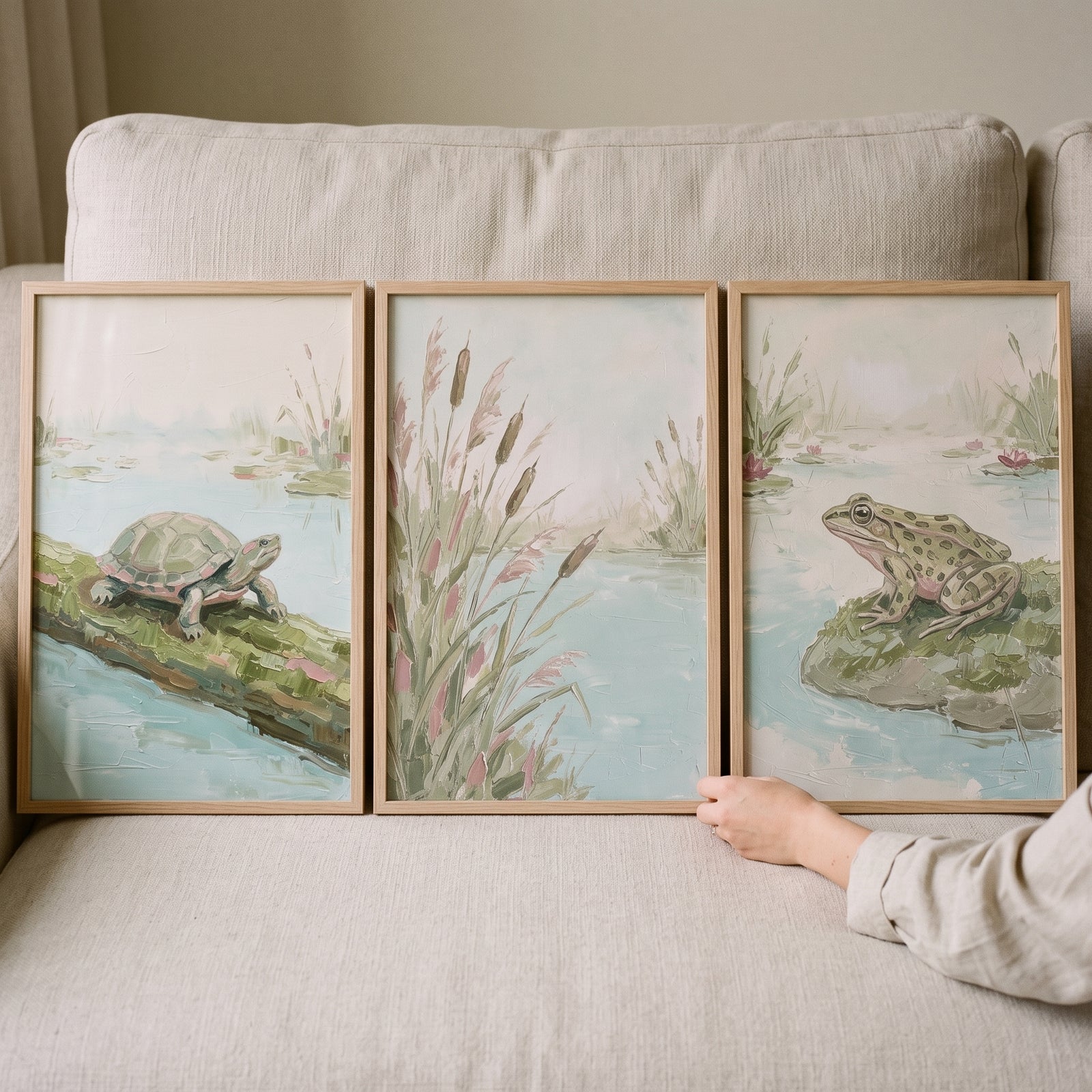 Serene misty sage pond wall art set of 3 depicts a turtle on a log, tall reeds, and a frog on a mossy stone.