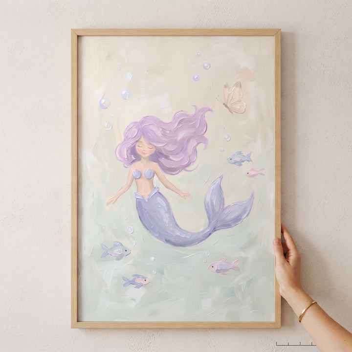 Serene swimming pastel mermaid wall art with lavender hair and colorful fish in a light wood frame.