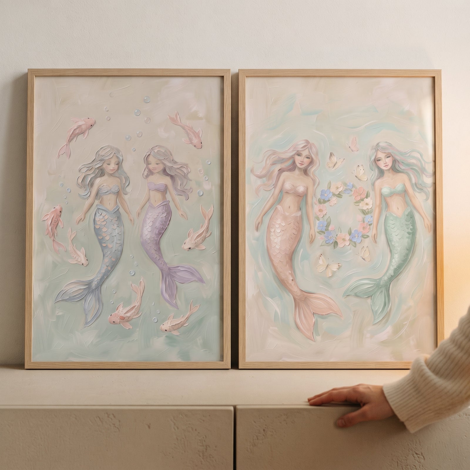 Serene textured pastel mermaid wall art set of 2 in wood frames featuring mermaids, fish, and floral wreaths.