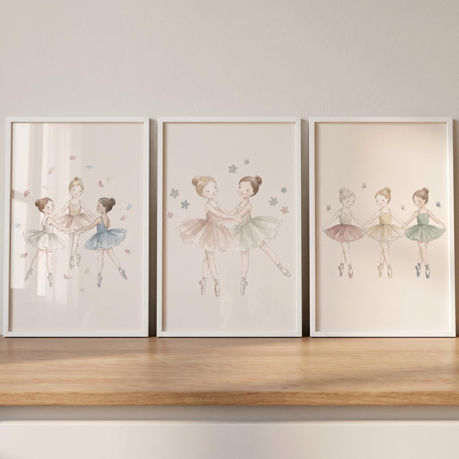 Serene watercolor dancing ballerina wall art set of 3 featuring young girls in tutus framed on a wooden shelf.