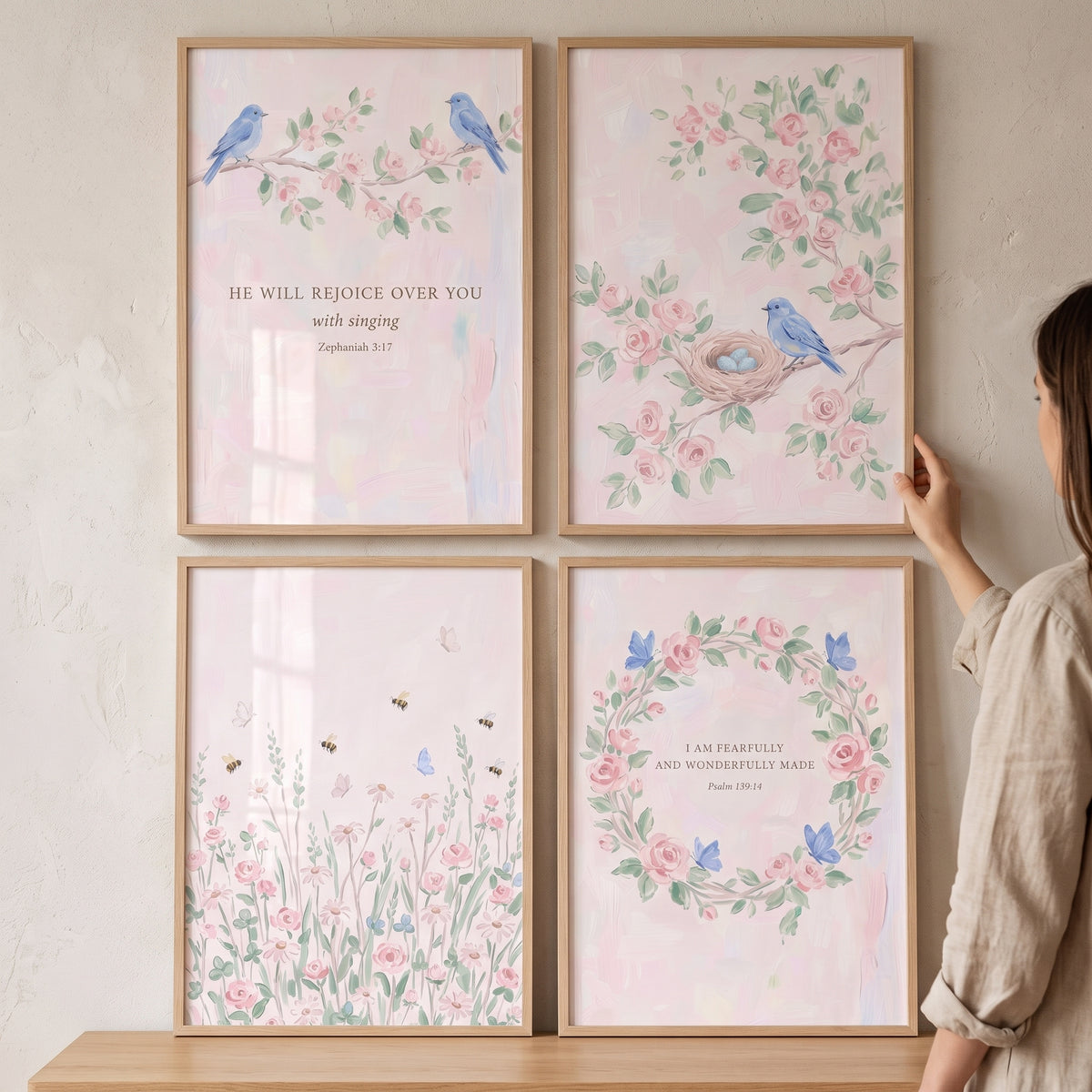 Shabby chic blossom garden wall art set of 4 with pink flowers, blue birds, and text in light wood frames on a wall.