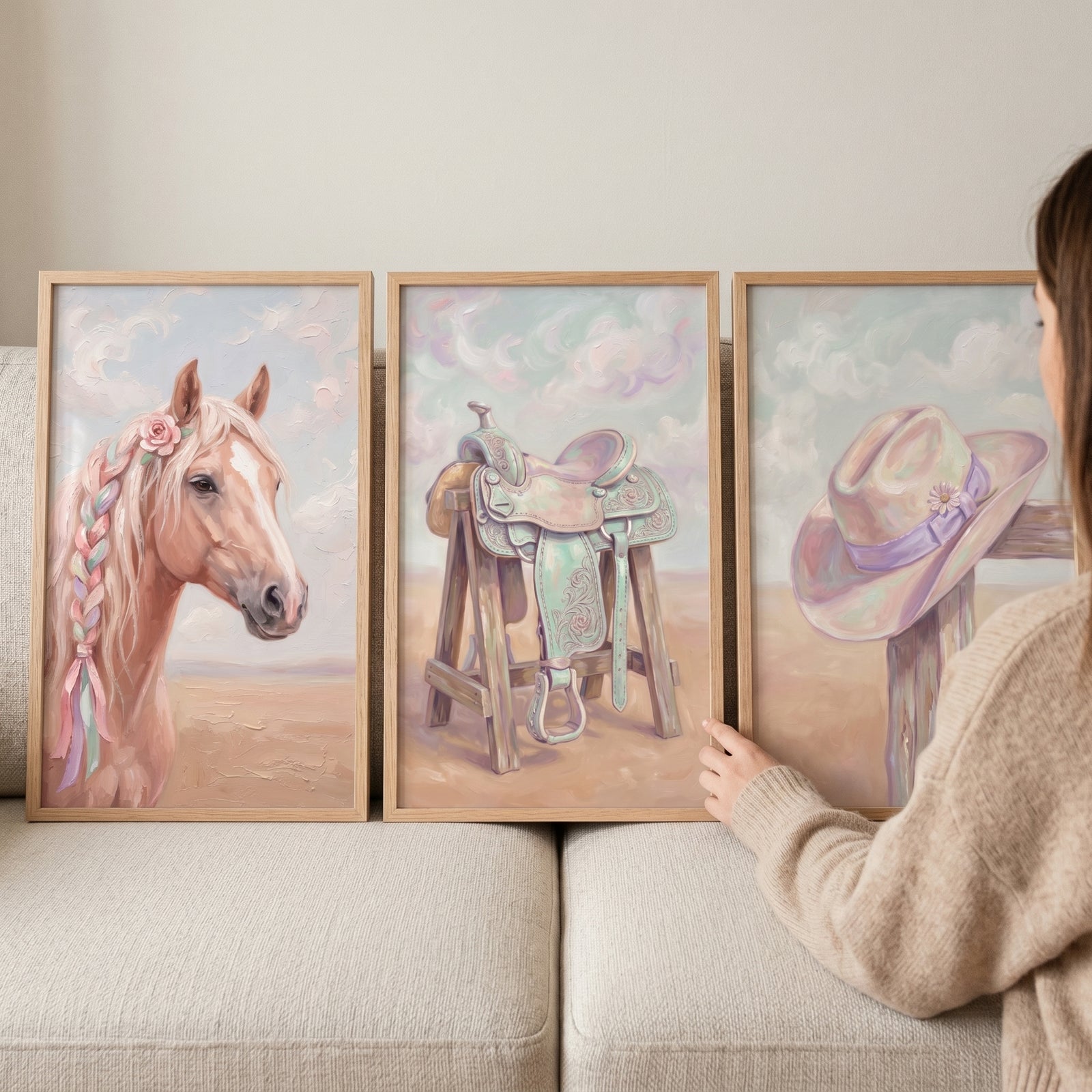 Shabby chic cowgirl gear wall art set of 3 featuring a horse with ribbons, a saddle, and a hat in soft pastel tones.