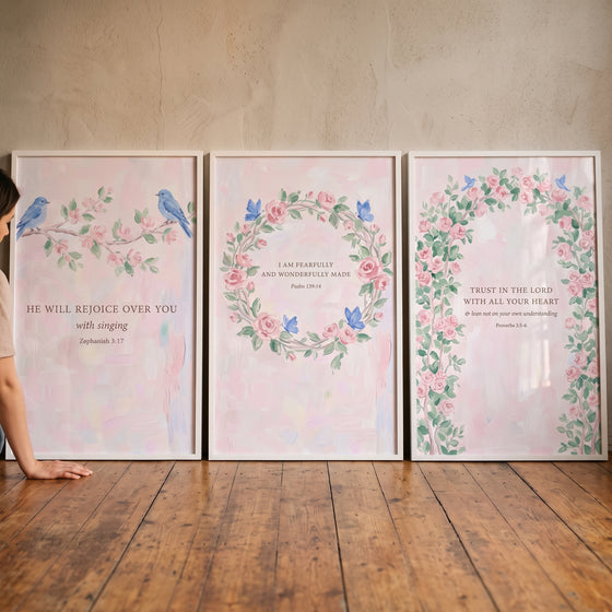 Shabby chic floral scripture wall art set of 3 featuring birds, butterflies, and pastel flowers on a wooden floor.