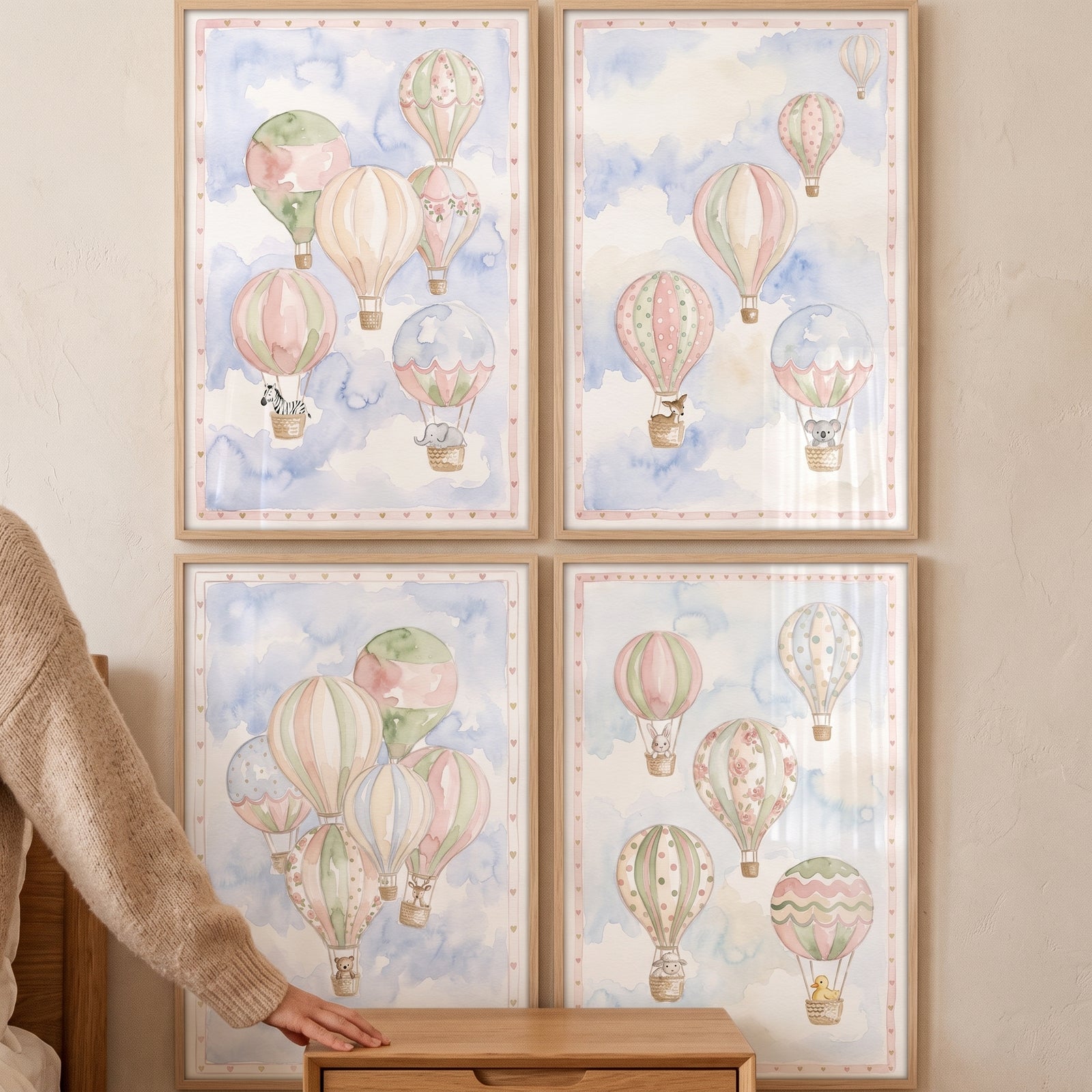 Shabby chic hot air balloon print set of 4 with cute animals in pastel watercolor framed on a wall.