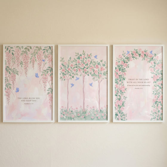Shabby chic pink garden wall art set of 3 with floral motifs, blue butterflies, and scripture in white frames.