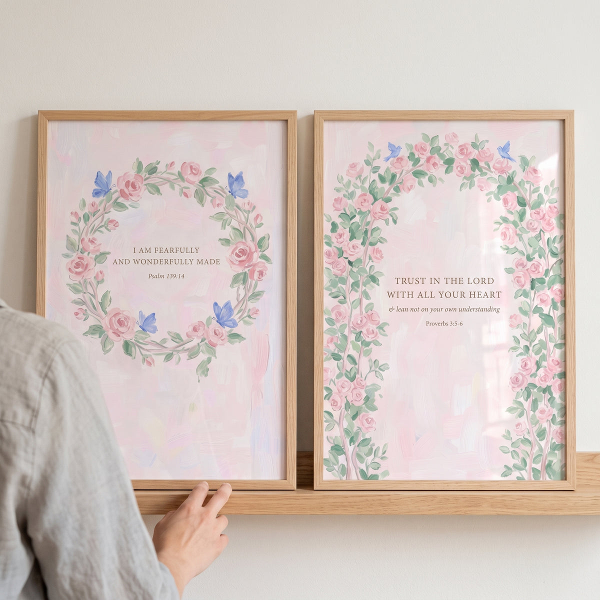 Shabby chic rose scripture wall art set of 2 featuring watercolor floral designs and bible verses on a wooden shelf.