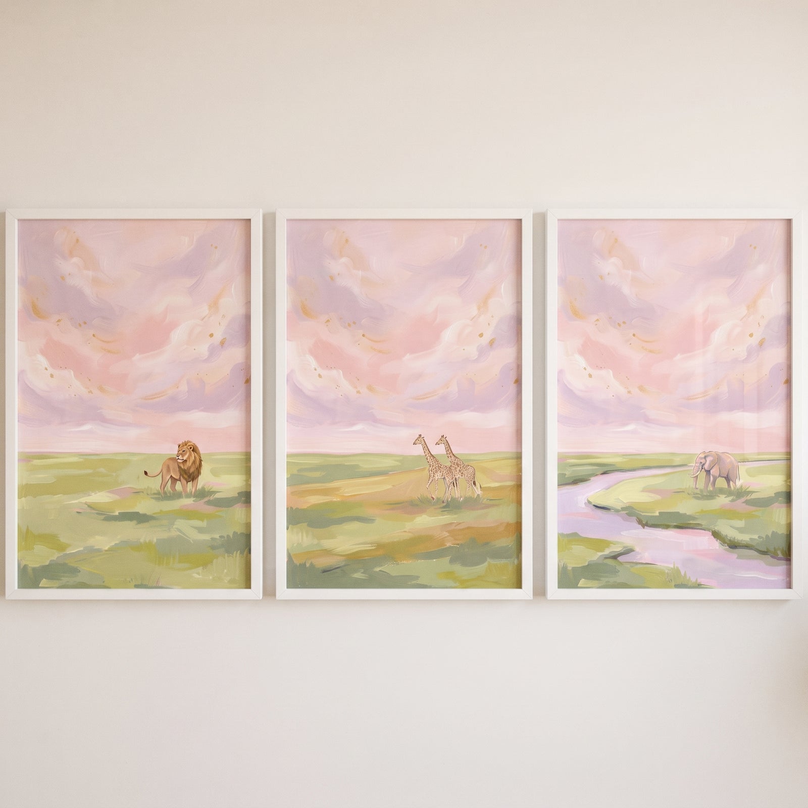 Shimmering gold safari animals wall art set of 3 featuring a lion, giraffes, and an elephant under a pastel pink sky.
