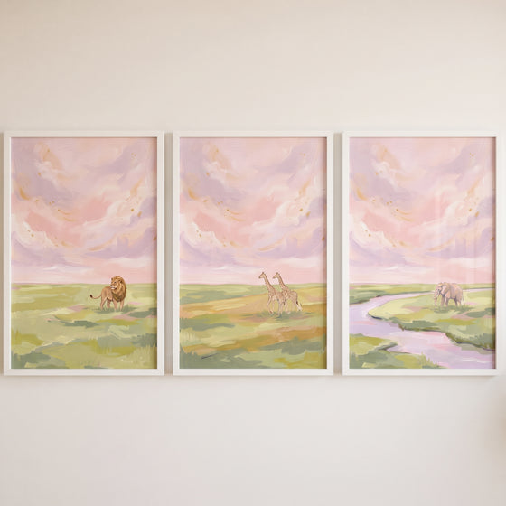 Shimmering gold safari animals wall art set of 3 featuring a lion, giraffes, and an elephant under a pastel pink sky.
