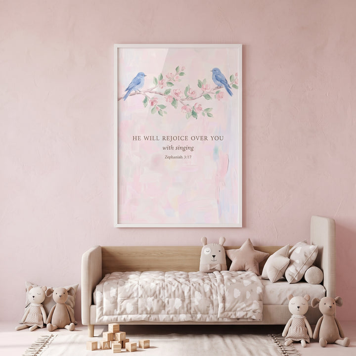 Singing verse blue bird bible wall art hangs above a neutral daybed in a soft pink nursery with stuffed animals.