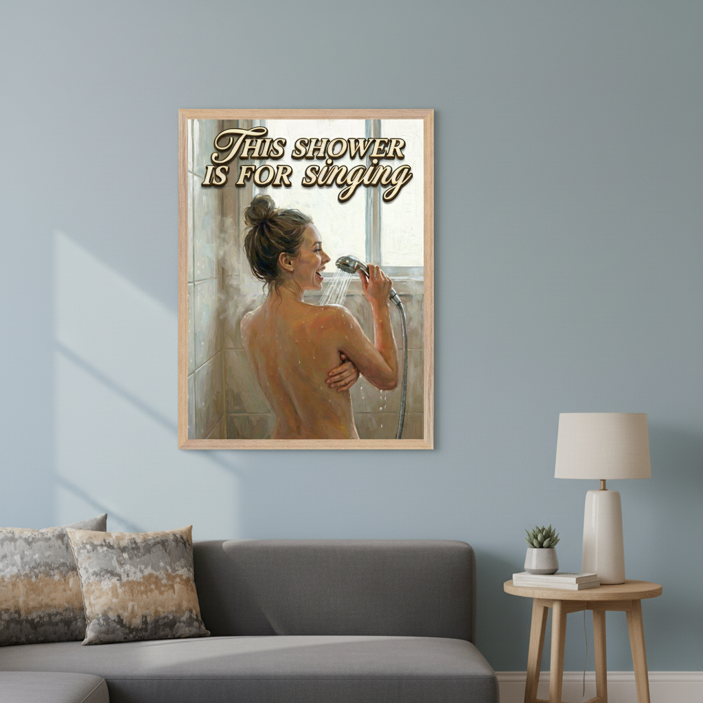 Modern living room with a gray sectional sofa and a light wood side table. A large framed painting of a woman showering and singing into the showerhead, with text 'THIS SHOWER IS FOR singing', hangs on the light blue wall above the sofa.