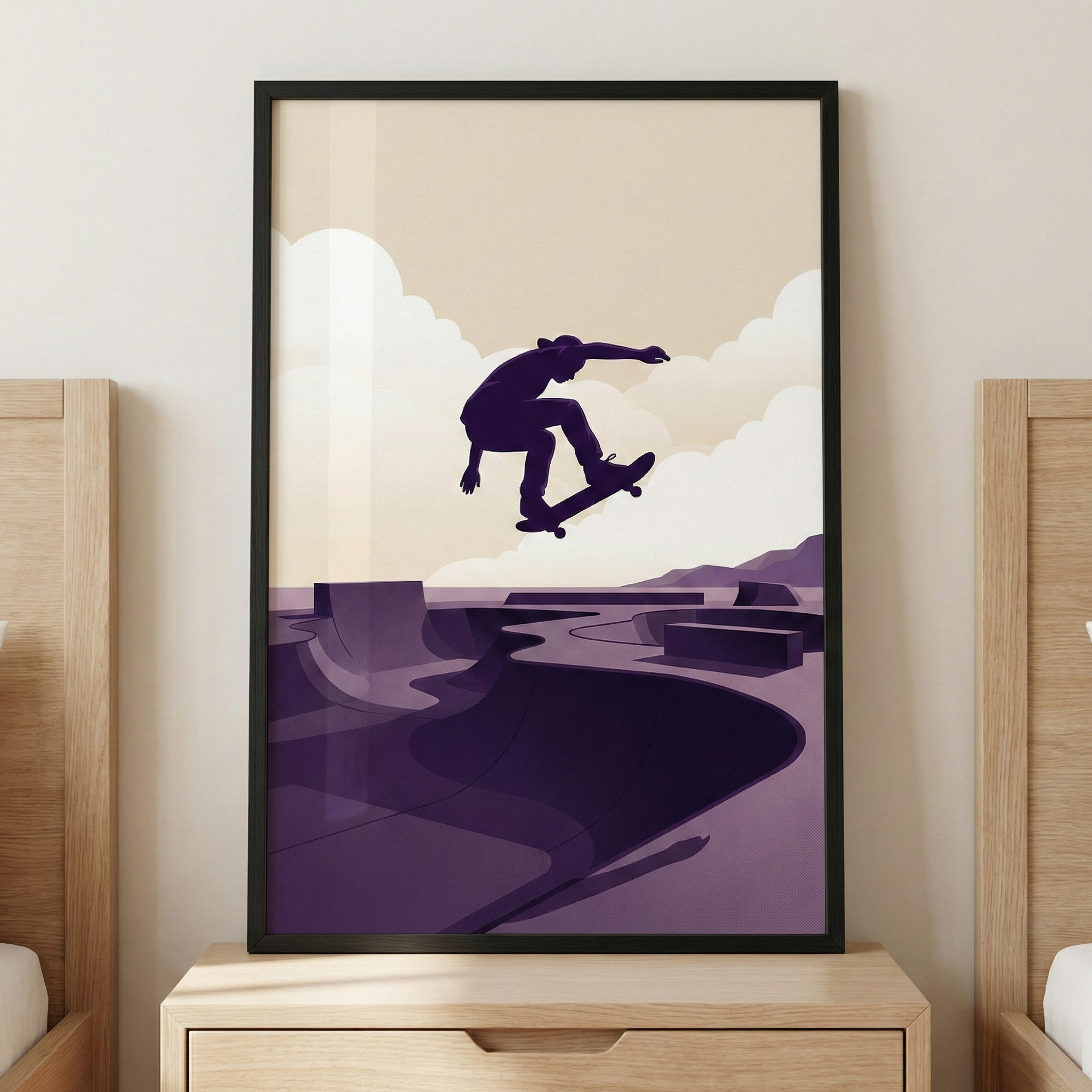 A minimalist graphic illustration is displayed in a black rectangular frame, hanging on a neutral-colored wall above a light-toned wooden nightstand. The art is centered between the sides of two matching wooden bed frames.

The illustration itself features a dark silhouette of a skateboarder mid-air, performing a jump. Below the figure is a stylized skatepark rendered in shades of purple and plum, with smooth, curved ramps and bowls. 