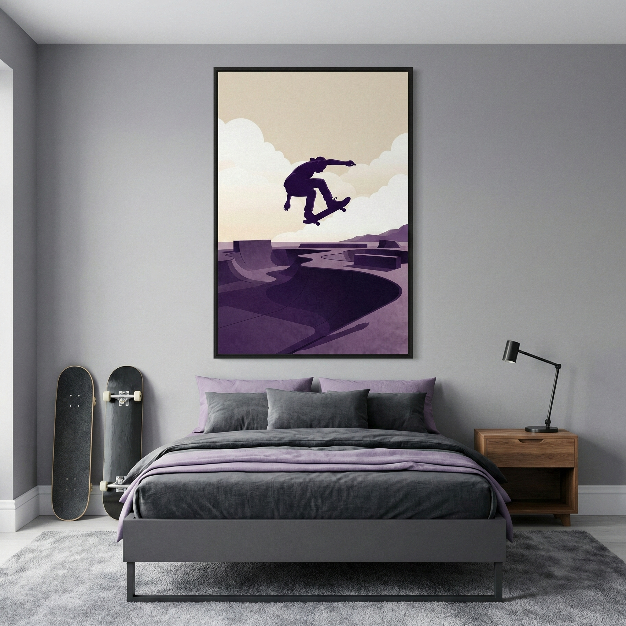 A modern bedroom featuring a grey wall and a large, framed graphic illustration centered above a bed. The illustration shows a silhouette of a skateboarder performing a trick over a skate park, with a background of layered clouds in shades of cream and purple. The bed has dark grey and light purple bedding. Two skateboards lean against the wall on the left, while a wooden nightstand with a black desk lamp sits on the right. A grey shag rug is on the floor.