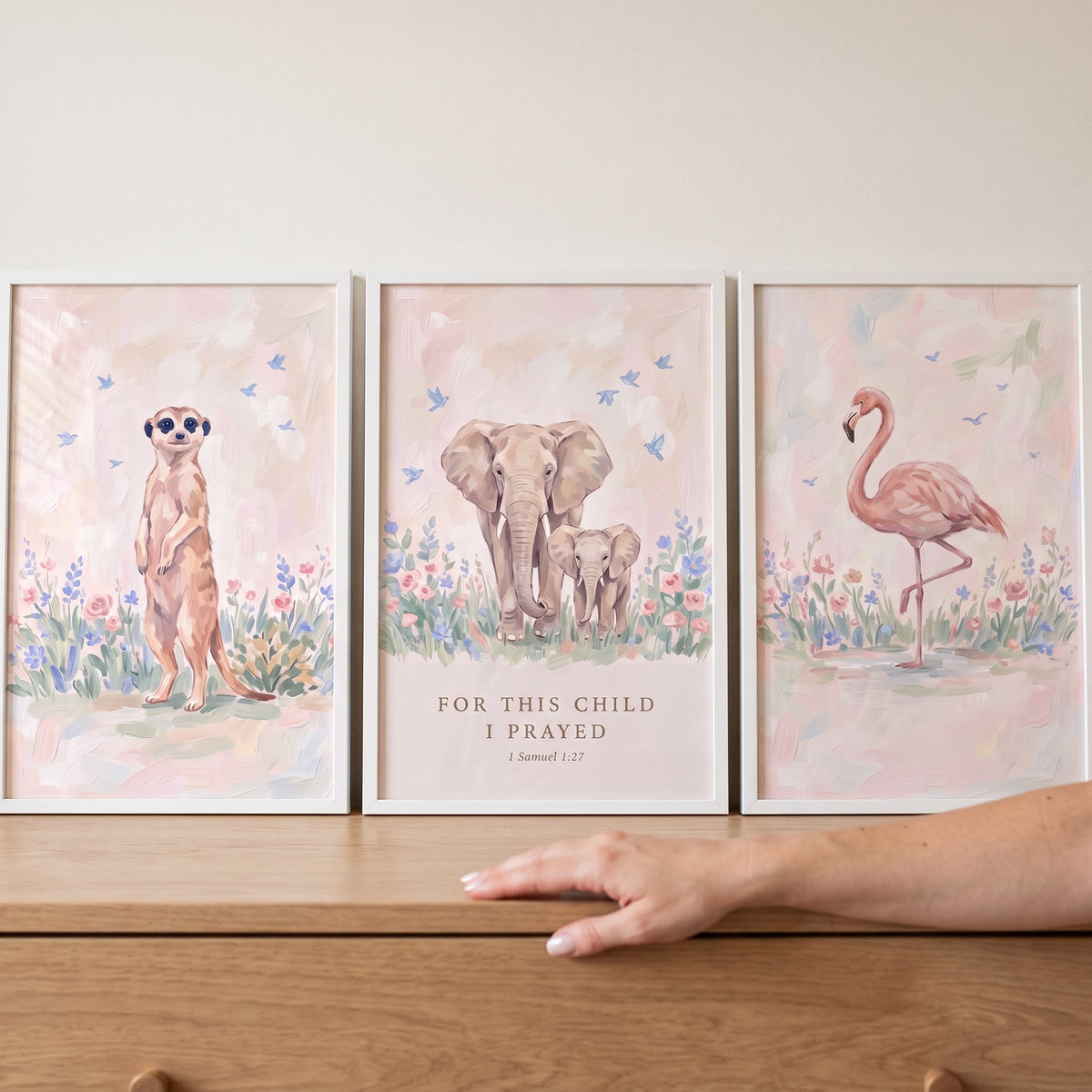 Sky bluebird savanna animals wall art set of 3 displays a meerkat, elephants, and a flamingo among pastel flowers.