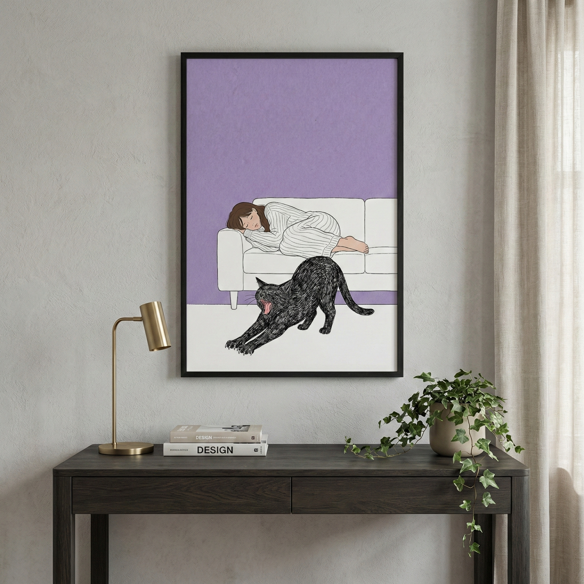 A framed illustration hangs on a light gray wall above a dark wood desk. The artwork depicts a woman with brown hair sleeping on a white sofa against a solid lavender background. In the foreground of the art, a black cat stretches its body across a white floor. On the desk below, there is a modern gold-toned lamp, a small stack of books with the word "DESIGN" on the spine, and a potted plant with green vines trailing down. To the right, soft white curtains hang near a window.