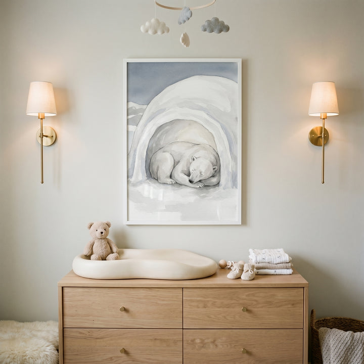Gold sconces flank sleeping igloo polar bear wall art above a wooden dresser with a changing pad and teddy bear.