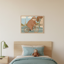 Kid's bedroom with a light wood bed and headboard. A framed, colorful illustration of a cartoon sloth riding a bicycle with the Eiffel Tower in the background hangs centered above the bed. A green lamp sits on a nightstand to the left, and a sloth plushie is on the bed.